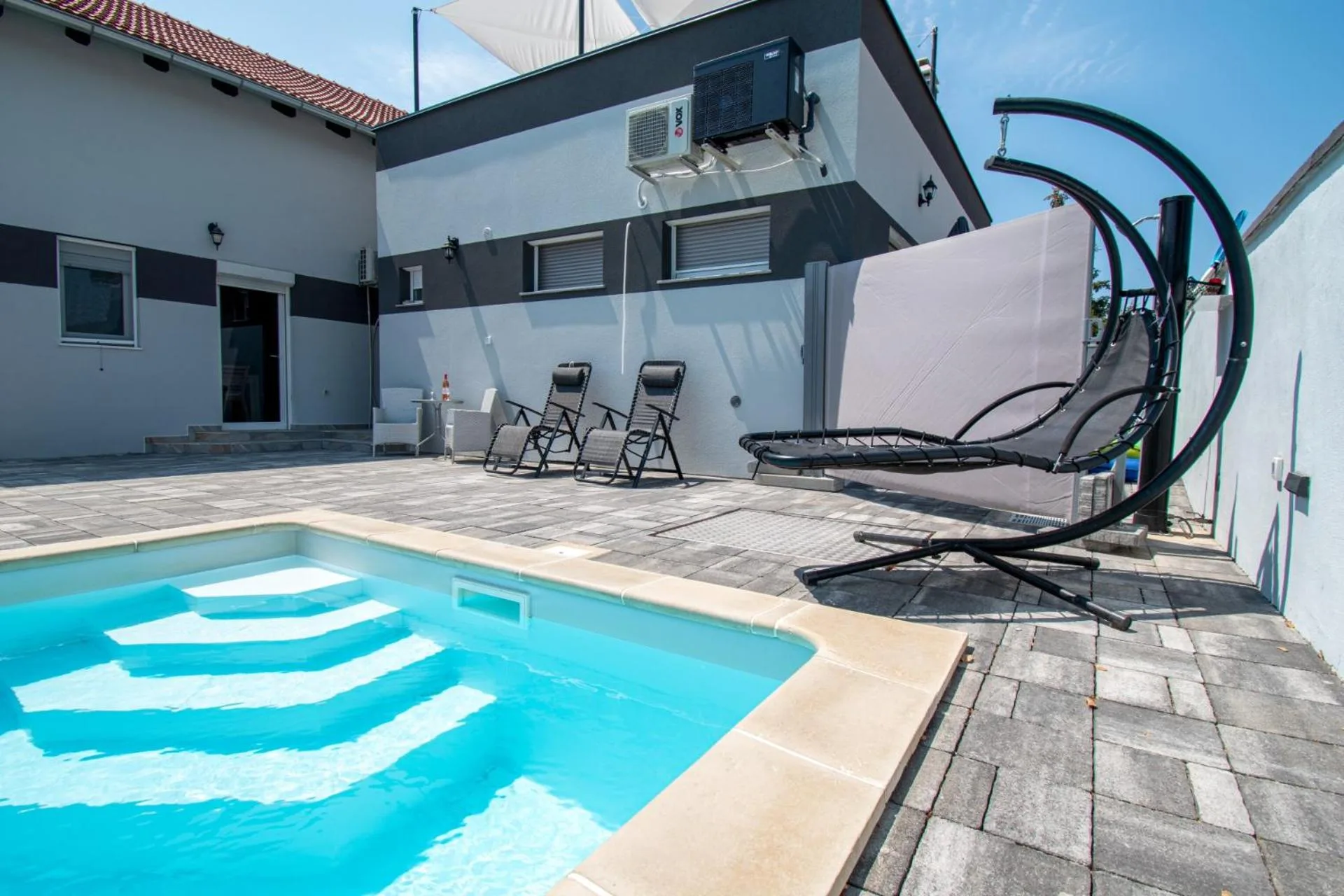 Hanging chair beside the private pool