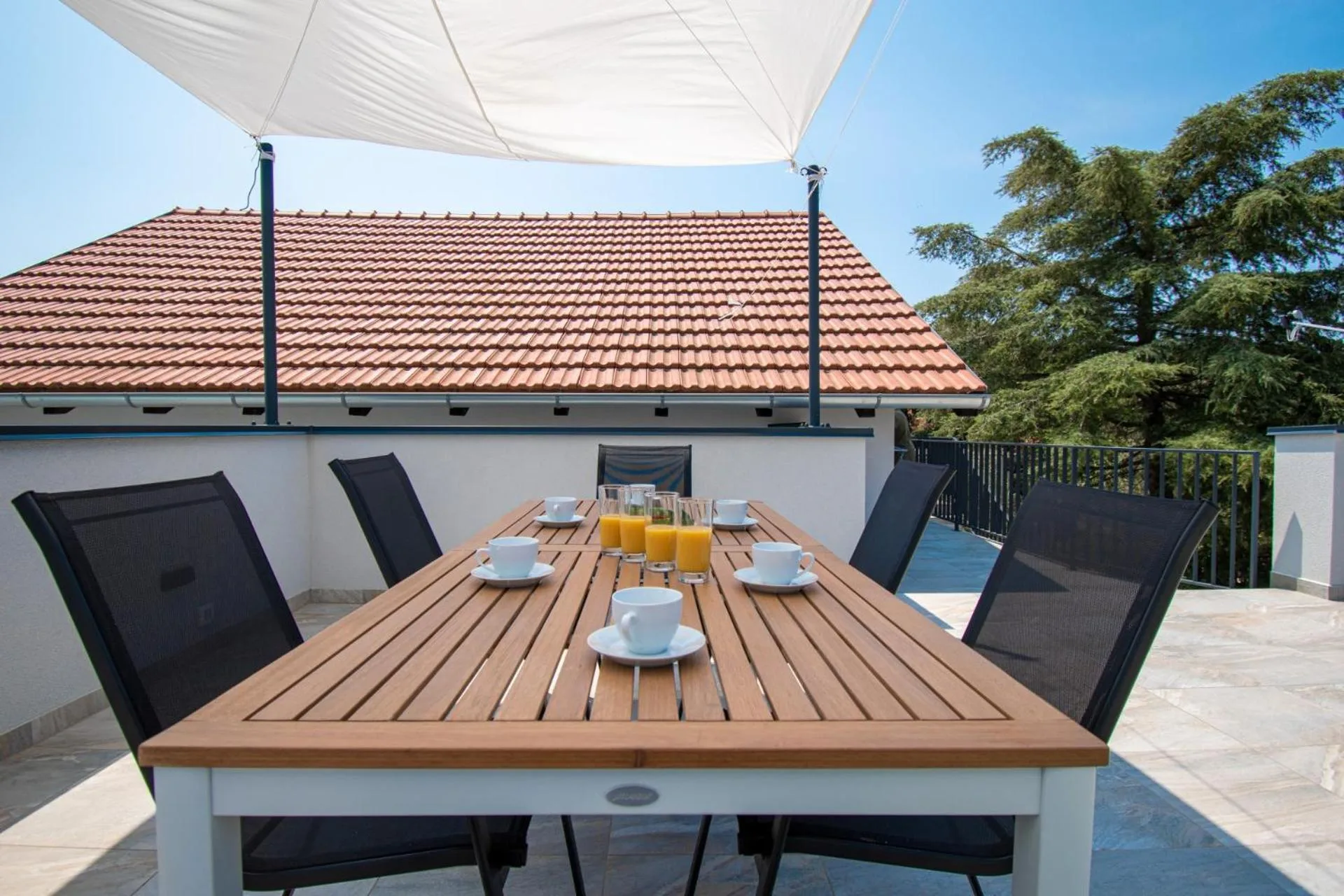 Dining table under the sail shade on the upper terrace